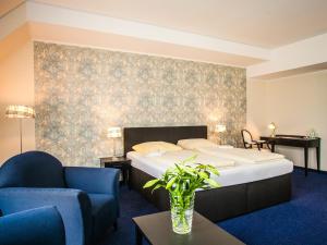 En eller flere senge i et værelse på Ahauser Land & Golfhotel