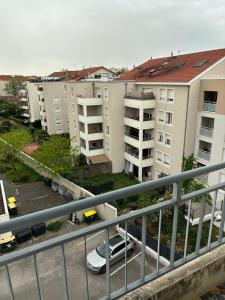 einen Blick über einen Parkplatz mit Apartmentgebäuden in der Unterkunft Appartement des merveilles in Vénissieux