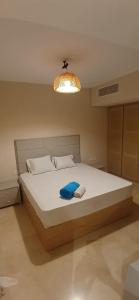 Un dormitorio con una cama con una toalla azul encima. en El Gouna, en Hurghada