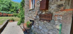 um edifício de pedra com um sinal na lateral em Ferienhaus mit Privatpool für 6 Personen ca 155 qm in Pescaglia, Toskana Provinz Lucca em Pescaglia