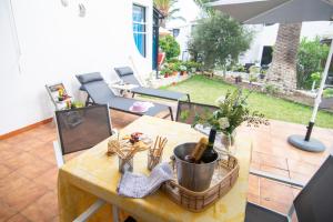a dining room table with an umbrella on a patio at Bungalow Relax Marine in Arona