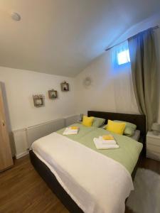 a bedroom with a bed with two towels on it at Cazare La Luiza b in Şura Mare