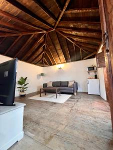 a living room with a couch and a table at Red House in Chío +13 photos