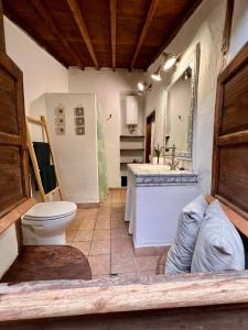 a bathroom with a toilet and a sink and a mirror at Red House in Chío