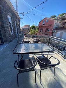 a black table and chairs on a balcony at OINEAS 