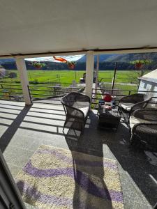 a balcony with chairs and a view of a farm at Njegusi-Cetinje in Njeguši