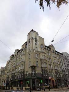 a large building on the corner of a street at Lāčplēša Central Apartments in Riga