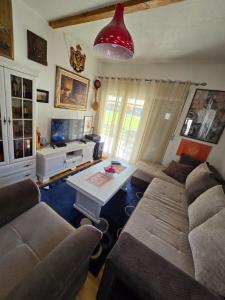 a living room with a couch and a table at Njegusi-Cetinje in Njeguši