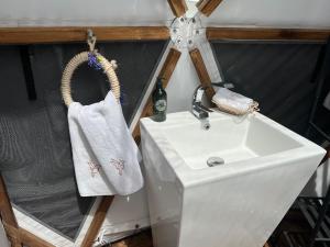 a bathroom sink with a towel hanging next to it at Casa Quincha Glamping in San Francisco