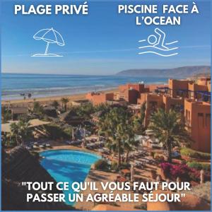a picture of a resort with an umbrella and the ocean at Paradis Plage Pieds dans l'eau - Superbe Appartement in Agadir