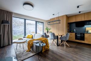 a living room with a couch and a table at Apartmán Prkenný důl in Prkenný Dŭl