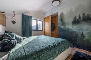 a bedroom with a bed and a painting on the wall at Apartmán Prkenný důl in Prkenný Dŭl