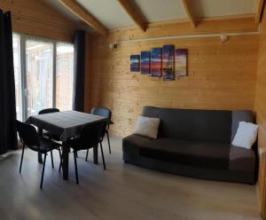 a living room with a couch and a table at Park Jesionów domki - Pleśna in Pleśna