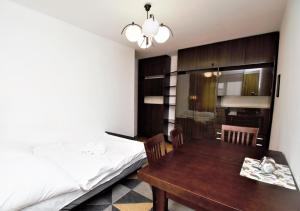 a bedroom with a table and a bed and a table and chairs at roomspoznan pl - Powstancow Wielkopolskich 23 - 24h self check-in in Poznań