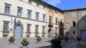 a large white building with flower pots in front of it at Casa Vacanza A DUE PASSI DA in Orvieto