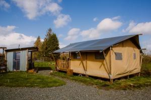 a yellow yurt with a black tarp on it at Rosgarron Safari Canvas Lodge Glorious Glamping in Magherafelt