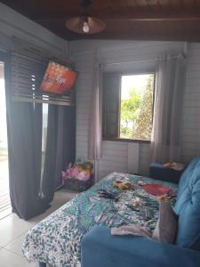 a bedroom with a bed and two windows at Hygge Sunset House in Ilha do Mel