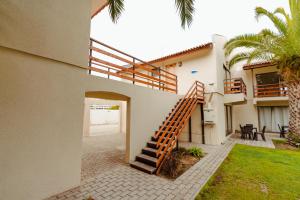 a house with a staircase leading up to a house at Agua Marina - La Serena in La Serena