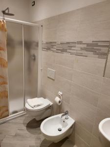 a bathroom with a toilet and a sink and a shower at Brezza Marina in Riomaggiore