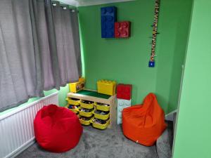 a childs room with two chairs and a table at The Lego themed house in Windsor