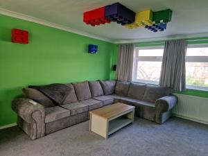 a living room with a couch and a table at The Lego themed house in Windsor