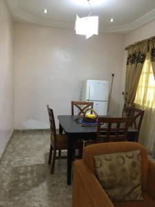 a kitchen with a dining room table and chairs at Cozy 2 bedroom serviced Apartment in Calabar