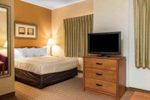 a hotel room with a bed and a flat screen tv at Extended Stay America Suites - Lancaster County in Mountville