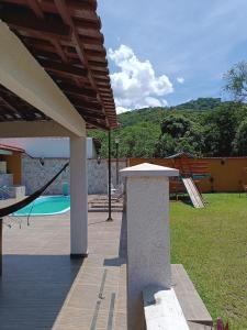 a patio with a view of a swimming pool at Pousada Vale dos Ventos in Guapimirim