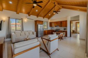 a living room with couches and a kitchen at Gran Pacifica Beach Resort & Homes in San Diego
