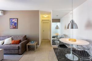 a living room with a couch and a table at Menara Morumbi in Sao Paulo