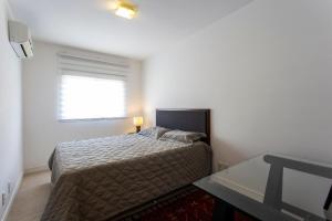 a small bedroom with a bed and a window at Menara Morumbi in Sao Paulo +31 photos