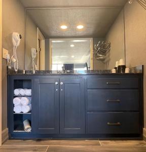 a bathroom with a blue cabinet with towels at Interstate Inn in Roland