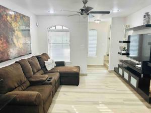 a living room with a couch and a flat screen tv at Sharyland Townhome in McAllen