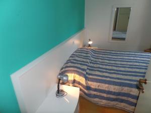 ein Schlafzimmer mit einem Bett mit einer gestreiften Decke in der Unterkunft Ferienhaus für 6 Personen ca 46 qm in Bibione, Adriaküste Italien Bibione und Umgebung in Bibione