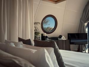 a bedroom with a bed and a mirror at 91 Athens Riviera, The Resort in Athens