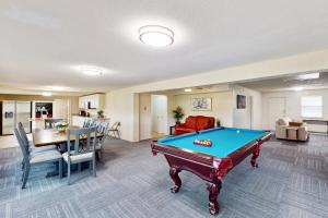 a living room with a pool table in it at Quinlan Ranch 