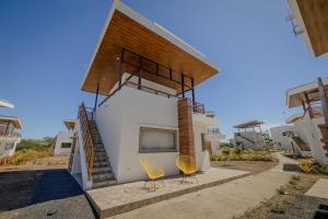 a house with two chairs and a tv on the side of it at Gran Pacifica Beach Resort & Homes in San Diego