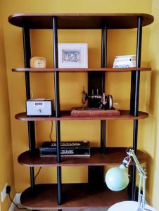 a shelf with a sewing machine and other items on it at The Cobbles - Central, Parking, Netflix & Woodburner in Hebden Bridge