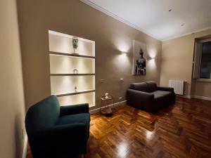 a living room with two chairs and a couch at La Fontana Luxury Apartment in Nettuno