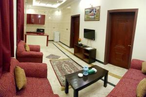 a living room with two couches and a coffee table at Triple One Hotel Suites in Abbottabad
