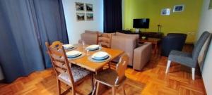 a living room with a table and chairs and a couch at Hisa Lescer in Kobarid
