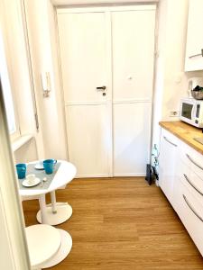 a small kitchen with a white table and a white door at viale Angelico in Rome