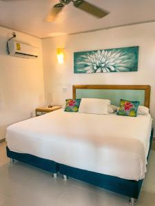 Ένα ή περισσότερα κρεβάτια σε δωμάτιο στο Hotel Cocoplum Beach