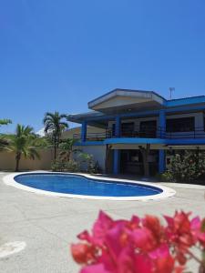 a house with a swimming pool in front of it at Costa Rica Beach Sanctuary in Bajamar