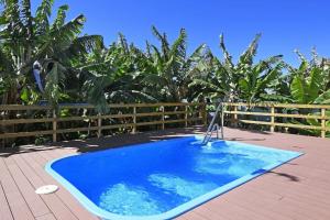 a blue swimming pool on a deck with a fence at Ferienhaus mit Privatpool für 6 Personen ca 130 qm in La Punta, La Palma Westküste von La Palma in Tijarafe
