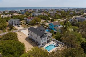 an aerial view of a house with a swimming pool at Aurora 6 BR Elevator Theater Rec Room Pool & Hot in Corolla