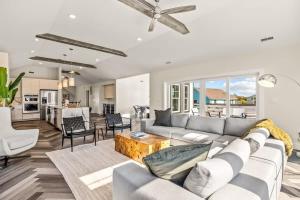 a living room with a couch and a table at Aurora 6 BR Elevator Theater Rec Room Pool & Hot in Corolla