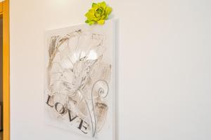 a picture with a yellow flower on top of it at Front Line Apartment Jakarta 2 in El Campello