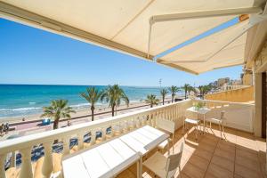 a balcony with a view of the beach and the ocean at Front Line Apartment Jakarta 2 in El Campello
