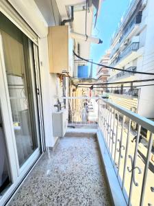 a balcony of a building with a view of a street at Oditee Thessaloniki Spartis str in Thessaloniki